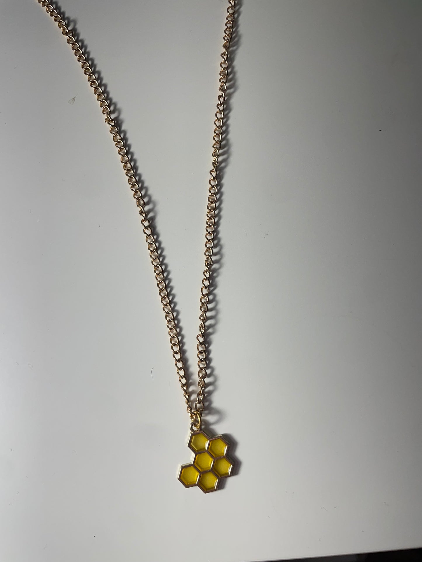 Honeycomb and bee necklaces